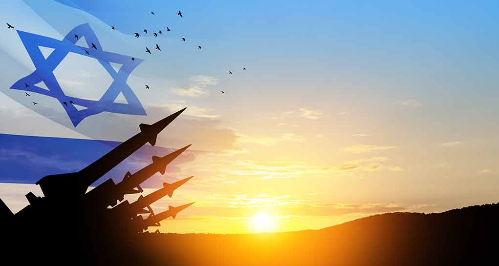 Israeli flag with silhouetted missiles at sunset