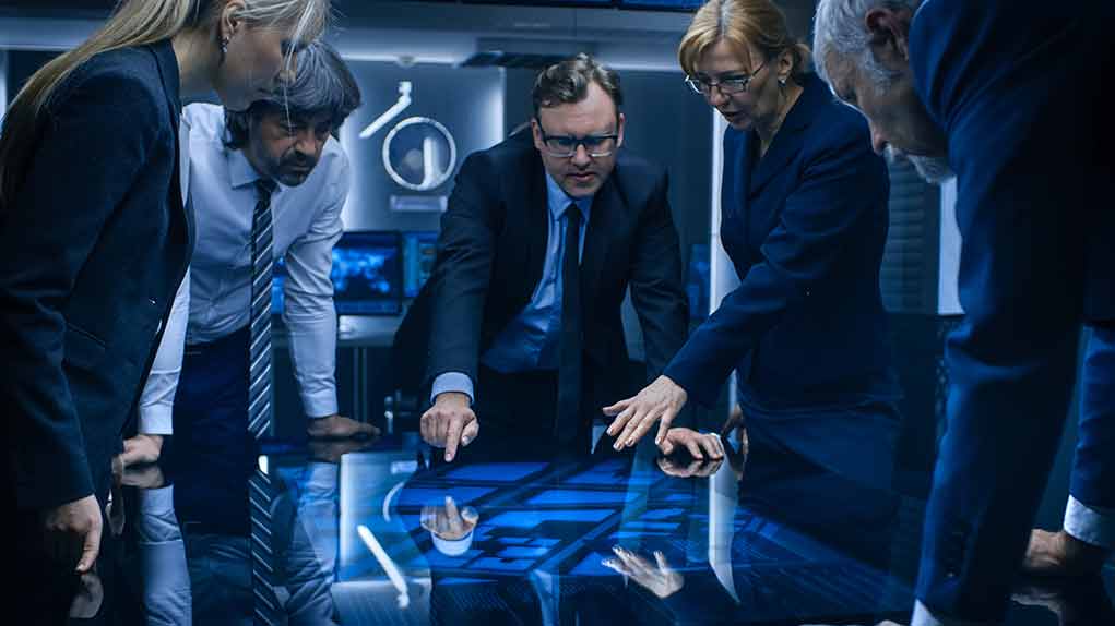 Business team reviews data on a large interactive table